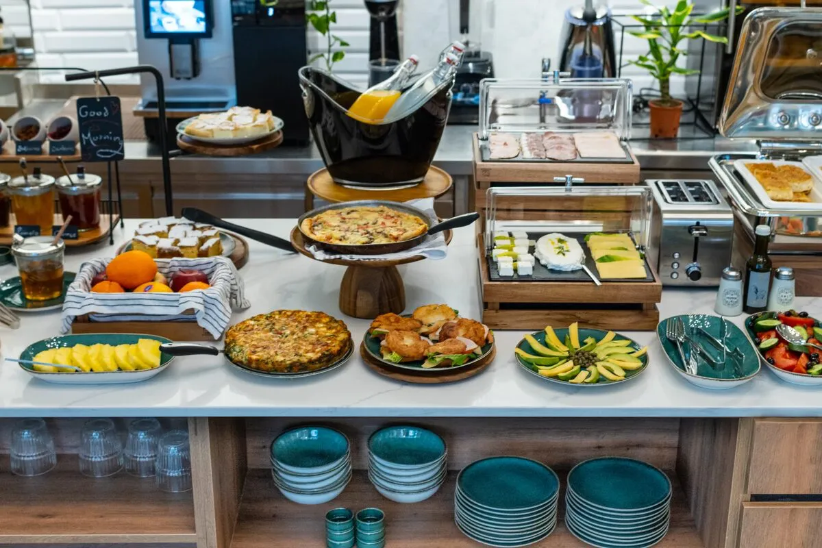 Greek breakfast spread at Gaia Athens featuring fresh local pastries, fruits, and traditional delicacies
